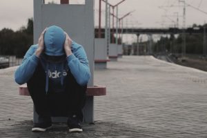 sad homeless teenager at the train station
